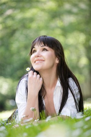 attractive brunette woman relaxing by lying on grass in park Stock Photo - Budget Royalty-Free & Subscription, Code: 400-04608703