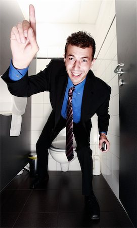 simsearch:400-04608943,k - nice businessman standing in restroom with the finger up Stock Photo - Budget Royalty-Free & Subscription, Code: 400-04608942