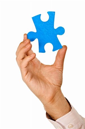 simsearch:640-01355058,k - Businessman holding a piece of blue puzzle - isolated Photographie de stock - Aubaine LD & Abonnement, Code: 400-04608986