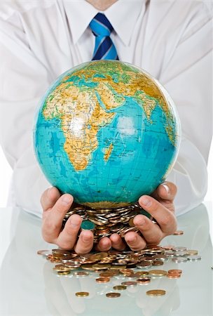 Businessman holding in his hands coins and a globe Stock Photo - Budget Royalty-Free & Subscription, Code: 400-04608983