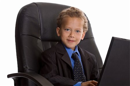 Young boy dressed as businessman with laptop Stock Photo - Budget Royalty-Free & Subscription, Code: 400-04609086