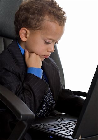 Young boy dressed as businessman with laptop Stock Photo - Budget Royalty-Free & Subscription, Code: 400-04609087