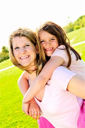 simsearch:400-04612785,k - Portrait of happy mother giving piggyback ride to child Stock Photo - Budget Royalty-Free & Subscription, Code: 400-04609126