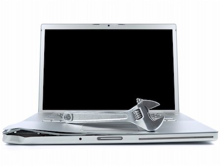 simsearch:400-05244427,k - A spanner over a damaged laptop isolated over white background. Black copy space on screen. Stock Photo - Budget Royalty-Free & Subscription, Code: 400-04609182