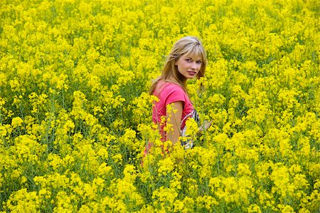 simsearch:400-04982004,k - Happy blond girl with pink t-shirt in a yellow field Stock Photo - Budget Royalty-Free & Subscription, Code: 400-04609367