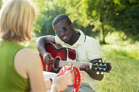 two friends playing guitar and tambourine outdoors Stock Photo - Budget Royalty-Free & Subscription, Code: 400-04609412
