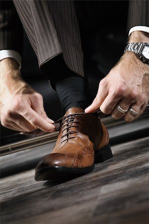 A businessman is lacing his shoes Stock Photo - Budget Royalty-Free & Subscription, Code: 400-04601297