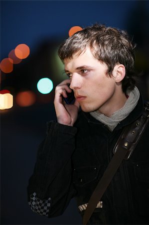 sad man talking phone - Portrait. Evening city lights in the background. Stock Photo - Budget Royalty-Free & Subscription, Code: 400-04601308