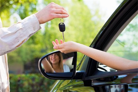 simsearch:400-04107635,k - close up of female with arm outstretched taking car keys from man. Copy space Photographie de stock - Aubaine LD & Abonnement, Code: 400-04601970