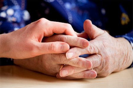 elderly praying - A young hand holding an elderly pair of hands Photographie de stock - Aubaine LD & Abonnement, Code: 400-04602896