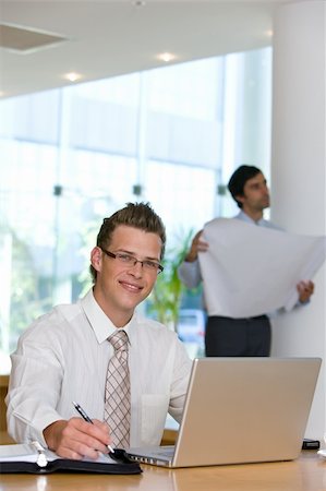 simsearch:400-04171780,k - Confident young business man working on laptop Stock Photo - Budget Royalty-Free & Subscription, Code: 400-04603561