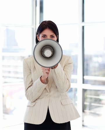 simsearch:400-09223567,k - Attractive businesswoman shouting through megaphone looking to the camera Stock Photo - Budget Royalty-Free & Subscription, Code: 400-04614543