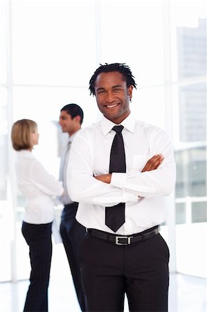 simsearch:400-07246047,k - Confident African businessman smiling at the camera with folded arms Foto de stock - Super Valor sin royalties y Suscripción, Código: 400-04614556