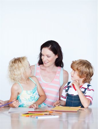 Mother helping her children doing homework at home Stock Photo - Budget Royalty-Free & Subscription, Code: 400-04614614