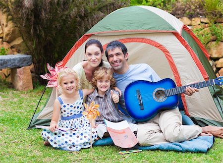 Happy family playing a guitar in a tent Stock Photo - Budget Royalty-Free & Subscription, Code: 400-04614620