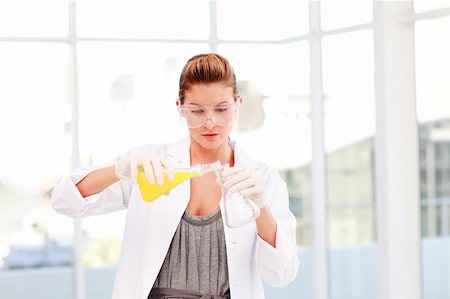 simsearch:400-06078063,k - Blond female scientist examinig a test-tube in a laboratory Stock Photo - Budget Royalty-Free & Subscription, Code: 400-04614654