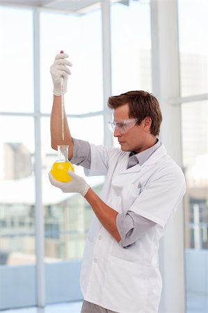 simsearch:400-05218769,k - Scientist examining a test-tube in a laboratory Stock Photo - Budget Royalty-Free & Subscription, Code: 400-04614651