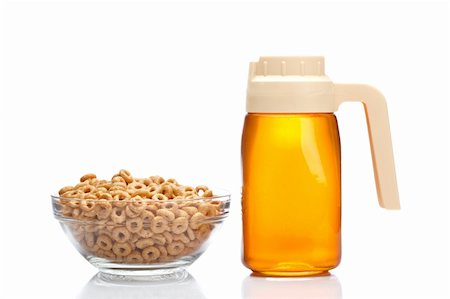 dry cured - Honey pitcher and glass bowl of cornflakes, reflected on white background Stock Photo - Budget Royalty-Free & Subscription, Code: 400-04615612