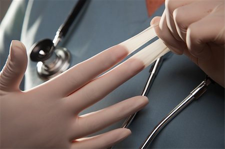 Abstract Image of Doctor Taking Off Latex Surgical Gloves. Foto de stock - Super Valor sin royalties y Suscripción, Código: 400-04615667