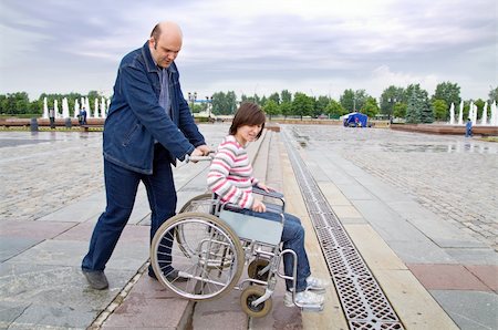 simsearch:400-05147195,k - Man pushing woman in wheelchair on steps Stock Photo - Budget Royalty-Free & Subscription, Code: 400-04615671