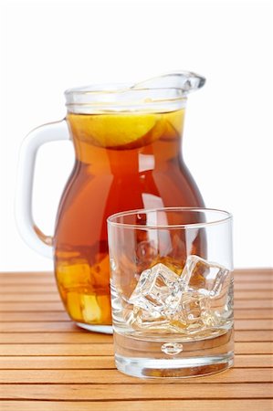 simsearch:400-06877048,k - Ice tea pitcher and empty glasss with icecubes on wooden background. Shallow depth of field Foto de stock - Royalty-Free Super Valor e Assinatura, Número: 400-04615987