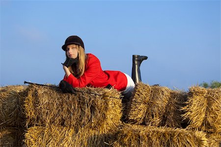 girl jockey / on a background of blue sky and hay Stock Photo - Budget Royalty-Free & Subscription, Code: 400-04616842