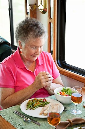 dinner prayer image - Christian senior woman saying grace over a healthy meal in her motor home. Stock Photo - Budget Royalty-Free & Subscription, Code: 400-04618007