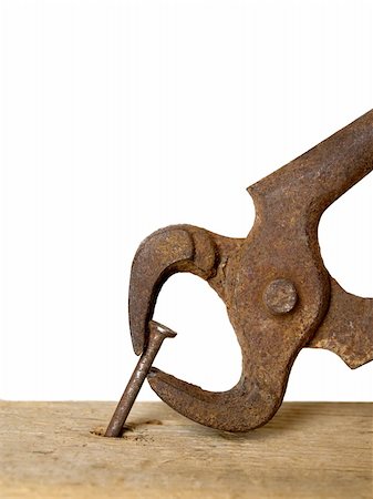 closeup of pincers pulling out the rotten nail out of the wood piece, over white background Stock Photo - Budget Royalty-Free & Subscription, Code: 400-04618820