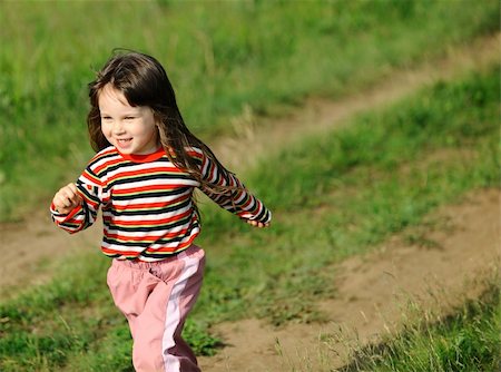 simsearch:400-05246924,k - The running girl on a green floor. The happy child on a spring meadow Photographie de stock - Aubaine LD & Abonnement, Code: 400-04619205