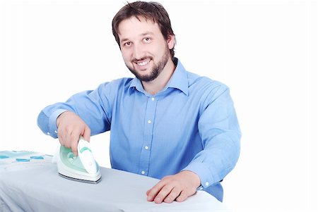 Isolated man in blue shirt is ironing with a smile on his face Stock Photo - Budget Royalty-Free & Subscription, Code: 400-04619299