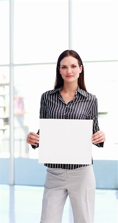 simsearch:400-04648812,k - Serious woman showing a big business card in office Stock Photo - Budget Royalty-Free & Subscription, Code: 400-04619531