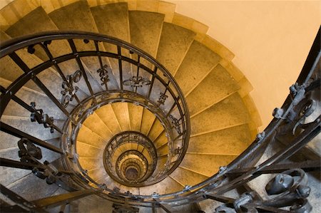stairs on tunnel - Spiral staircase, forged handrail and stone steps in old tower Stock Photo - Budget Royalty-Free & Subscription, Code: 400-04619644