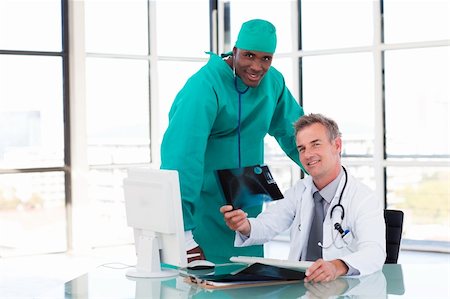 smiling industrial workers group photo - Doctor and surgeon looking at an X-ray in hospital Stock Photo - Budget Royalty-Free & Subscription, Code: 400-04610009