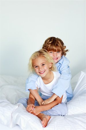 Little brother embracing her little sister in bed Stock Photo - Budget Royalty-Free & Subscription, Code: 400-04610021