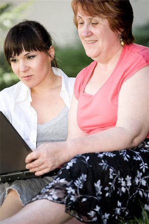 daughter helping elderly parent - happy family with laptop in garden Stock Photo - Budget Royalty-Free & Subscription, Code: 400-04610304