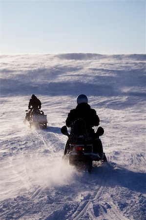 simsearch:400-05140122,k - Two people riding up a hill on snowmobiles Photographie de stock - Aubaine LD & Abonnement, Code: 400-04610537