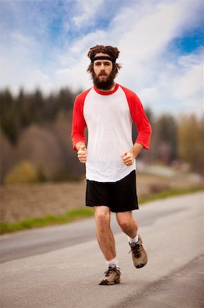 A tired retro style jogger running on a road outdoors Stock Photo - Budget Royalty-Free & Subscription, Code: 400-04610570