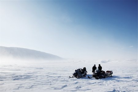 simsearch:400-05140080,k - Three snowmobiles on a winter landscape with blowing snow Fotografie stock - Microstock e Abbonamento, Codice: 400-04610586