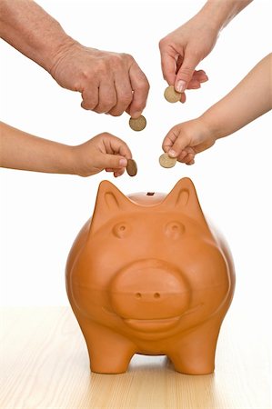 education savings - Hands of different generations putting coins into a piggy bank - isolated finances concept Stock Photo - Budget Royalty-Free & Subscription, Code: 400-04610727
