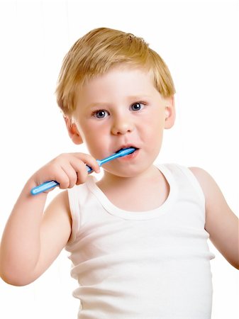a beautiful little boy cleans your teeth on a white background Stock Photo - Budget Royalty-Free & Subscription, Code: 400-04611113