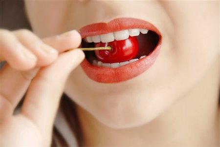 red ripe appetizing cherry in girl opened mouth white teeth Stock Photo - Budget Royalty-Free & Subscription, Code: 400-04611145