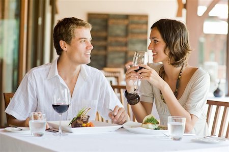 eastwestimaging (artist) - A young couple sitting at a table at an outdoor restaurant Fotografie stock - Microstock e Abbonamento, Codice: 400-04611277
