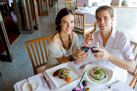 eastwestimaging (artist) - A young couple sitting together in a restaurant holding hands Fotografie stock - Microstock e Abbonamento, Codice: 400-04611282