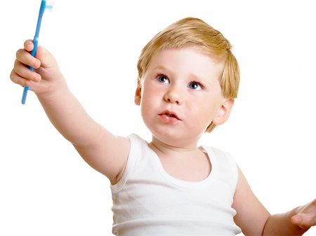 a beautiful little boy cleans your teeth on a white background Stock Photo - Budget Royalty-Free & Subscription, Code: 400-04612058