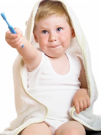 a beautiful little boy cleans your teeth on a white background Stock Photo - Budget Royalty-Free & Subscription, Code: 400-04612060