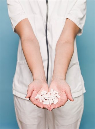 picture nurses giving medication - Nurse with several pills in her hands Stock Photo - Budget Royalty-Free & Subscription, Code: 400-04612174