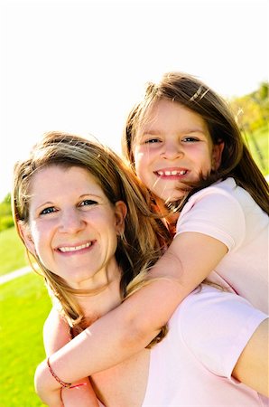 simsearch:400-04612785,k - Portrait of happy mother giving piggyback ride to child Stock Photo - Budget Royalty-Free & Subscription, Code: 400-04612782