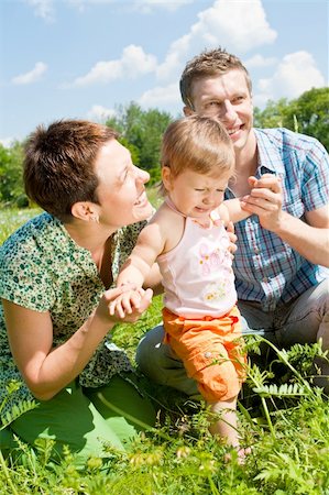 simsearch:400-07715953,k - Happy family in the green sunny meadow Stock Photo - Budget Royalty-Free & Subscription, Code: 400-04613149