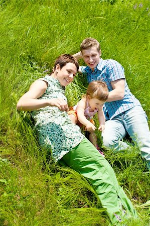 simsearch:400-07715953,k - Family lying in the green meadow grass Stock Photo - Budget Royalty-Free & Subscription, Code: 400-04613150