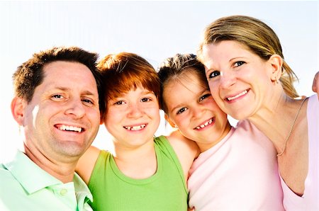 simsearch:400-04115211,k - Portrait of happy family of four hugging and smiling Foto de stock - Super Valor sin royalties y Suscripción, Código: 400-04613239